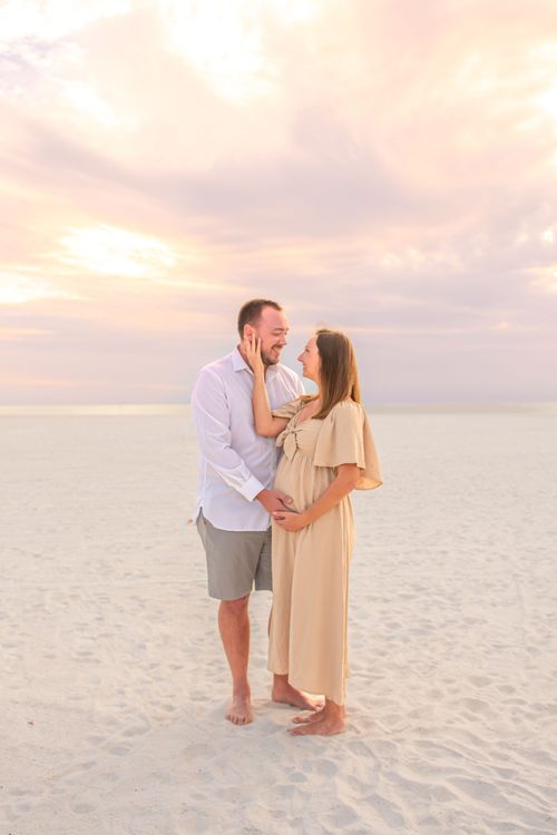 maternity photo of couple at beach sunset for a photography portfolio