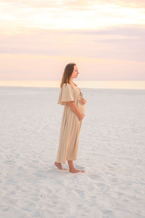 maternity photo of woman at beach sunset for a photography portfolio