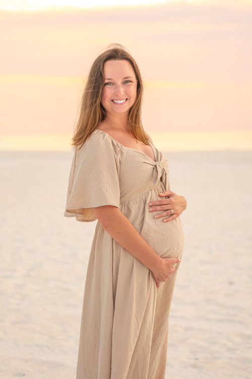 maternity photo of woman at beach sunset for a photography portfolio