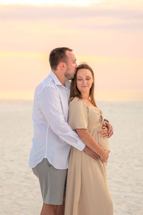 maternity photo of couple at beach sunset for a photography portfolio