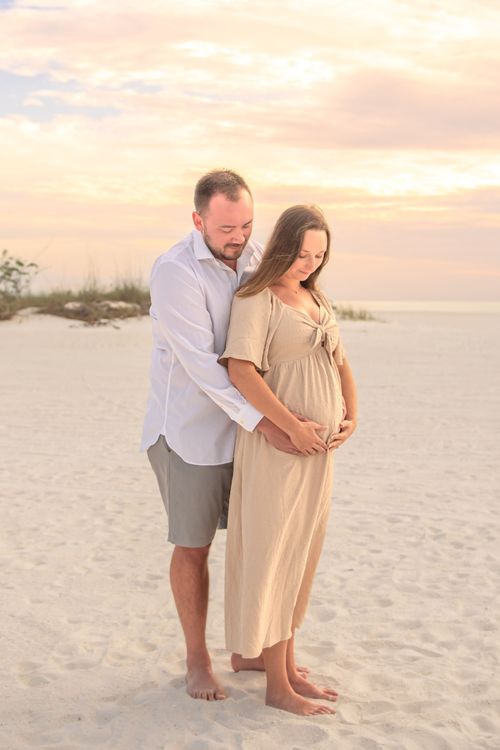 maternity photo of couple at beach sunset for a photography portfolio