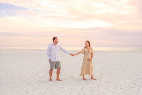 maternity photo of couple at beach sunset for a photography portfolio