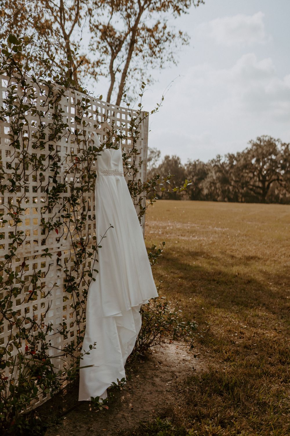 Ivory gown Lace details Long train Soft waves Floral crown Grey suit Blush tie