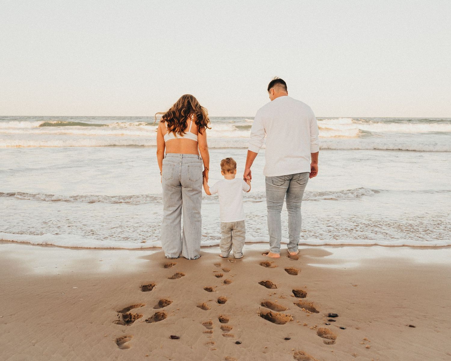 Footprints in the sand moment during a family session at Rainbow Beach, Queensland with Nicole Bailey Photography
