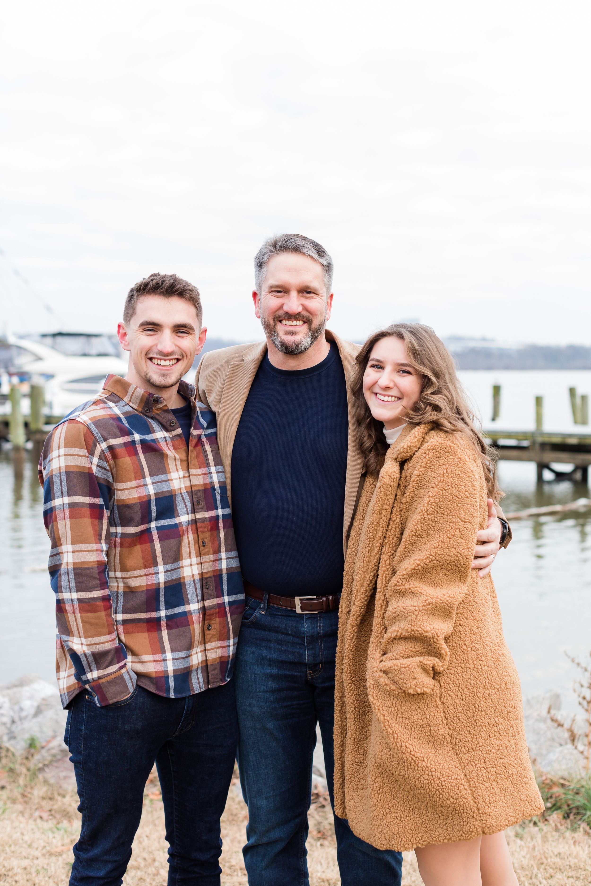 Dad posing with son and daughter in Old Town Alexandria waterfront in winter