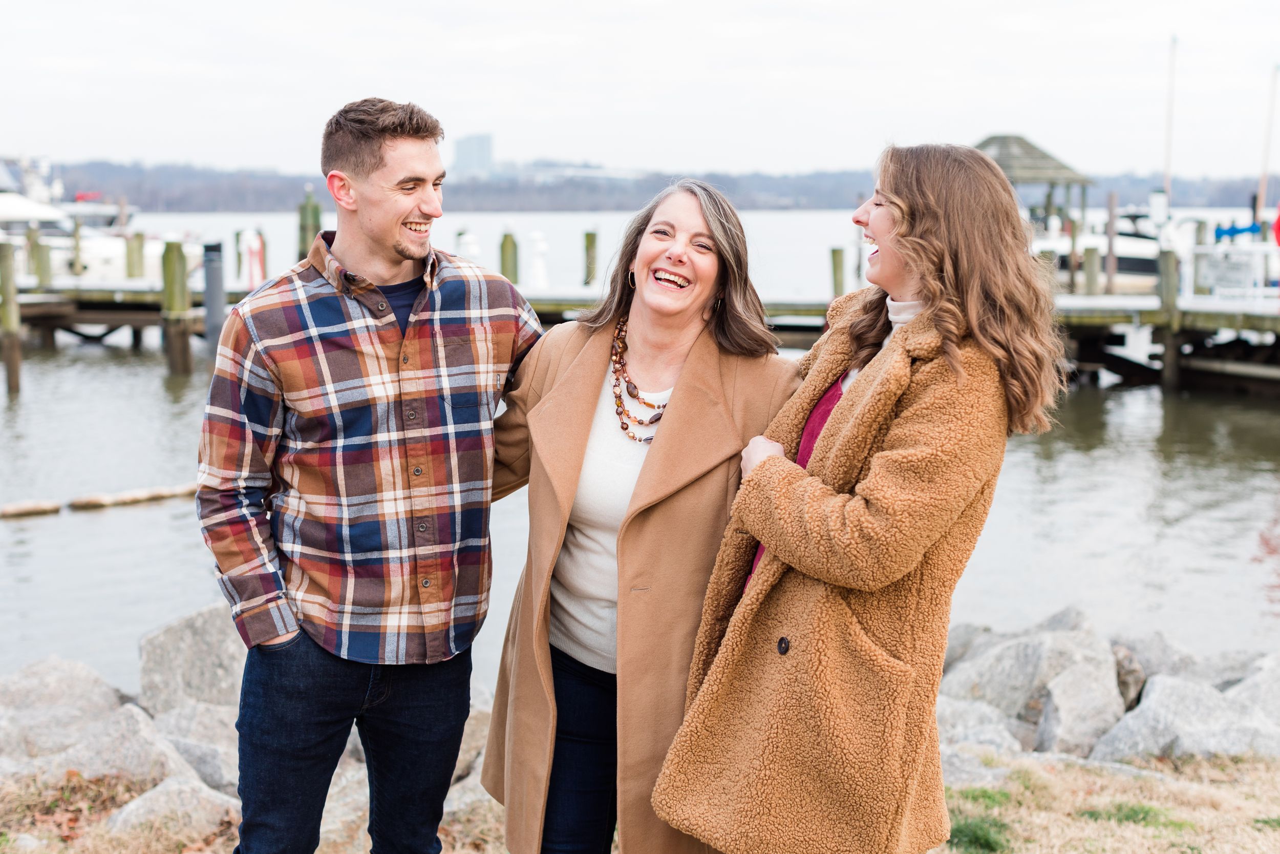 Mom with son and daughter posing in Old Town Alexandria waterfront in winter