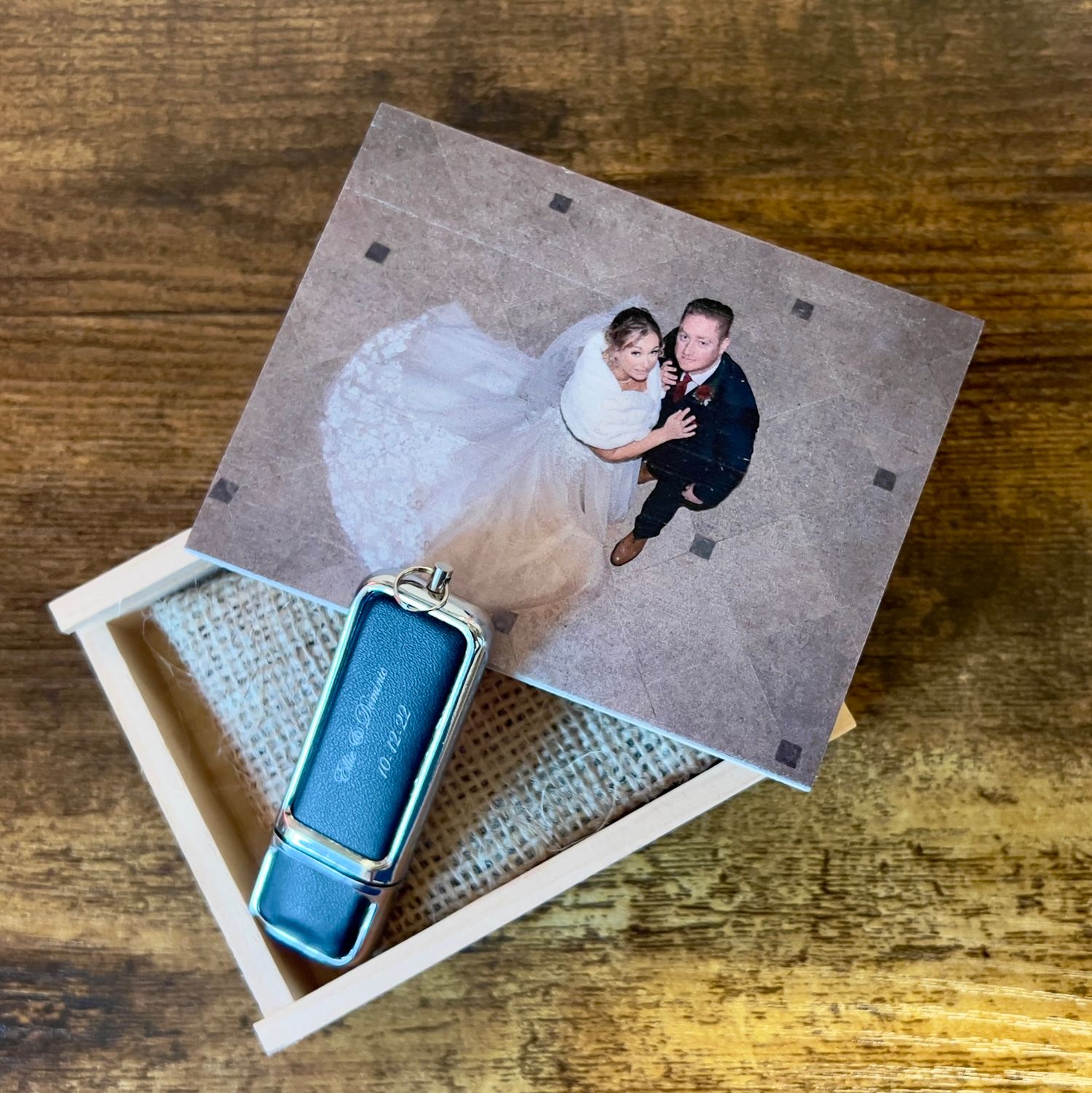 Wedding photo and USB drive displayed in a wooden keepsake box.