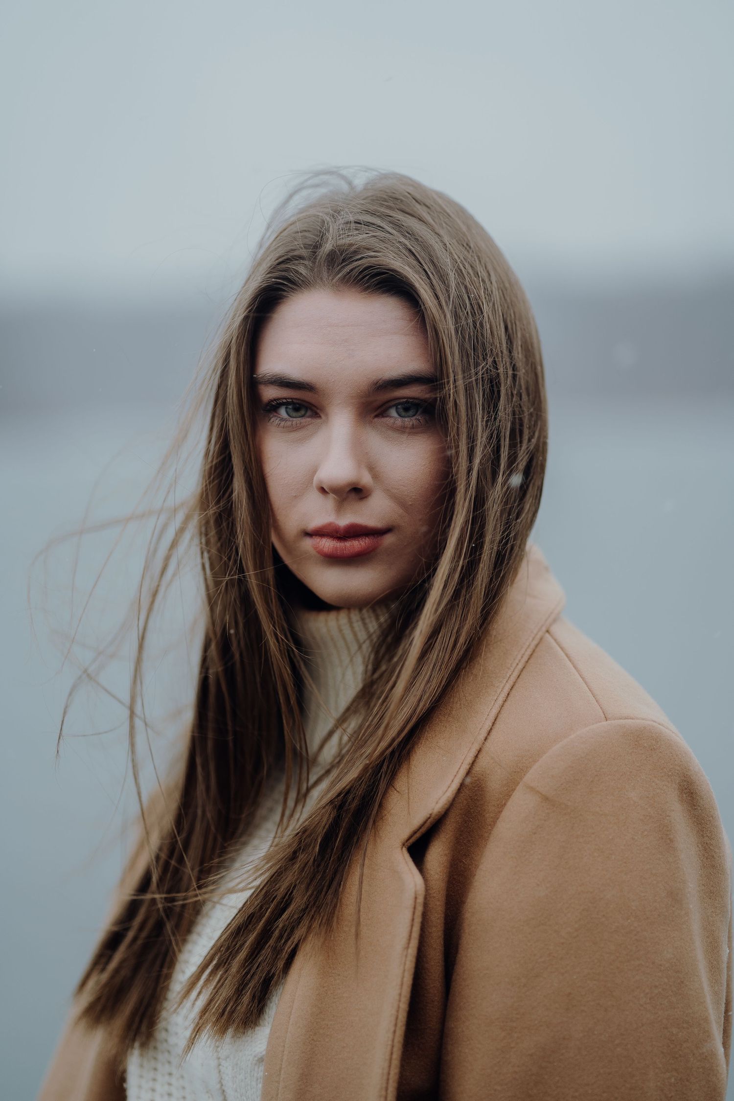 Portrait of beautiful young woman with snow flurries.