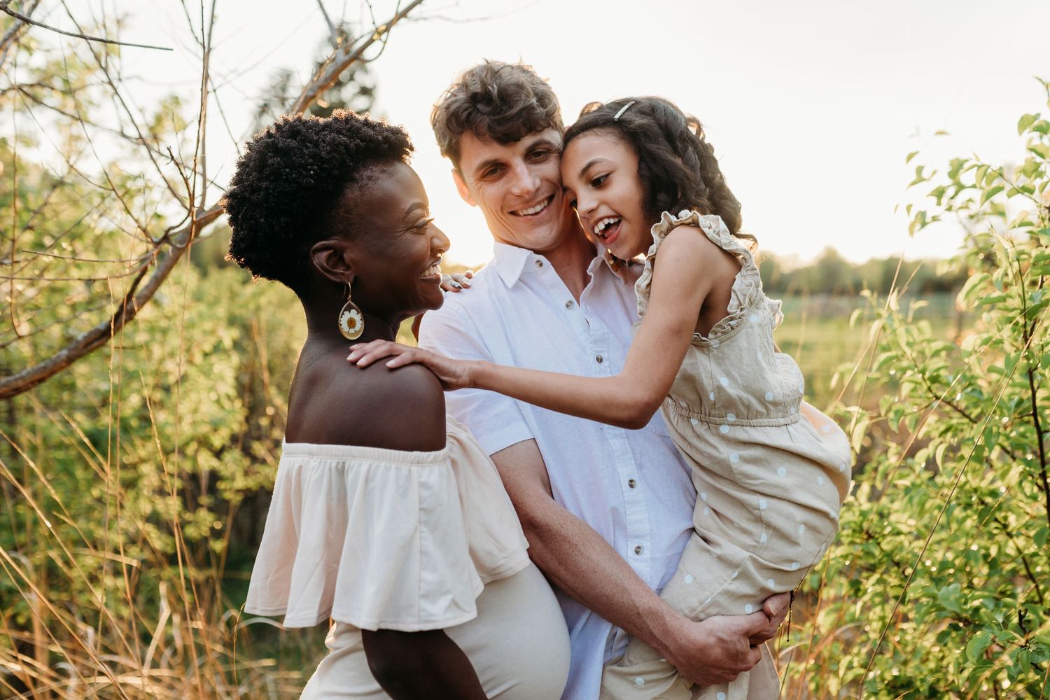 Mom and dad play with little girl during their family photo session at Overlook Park