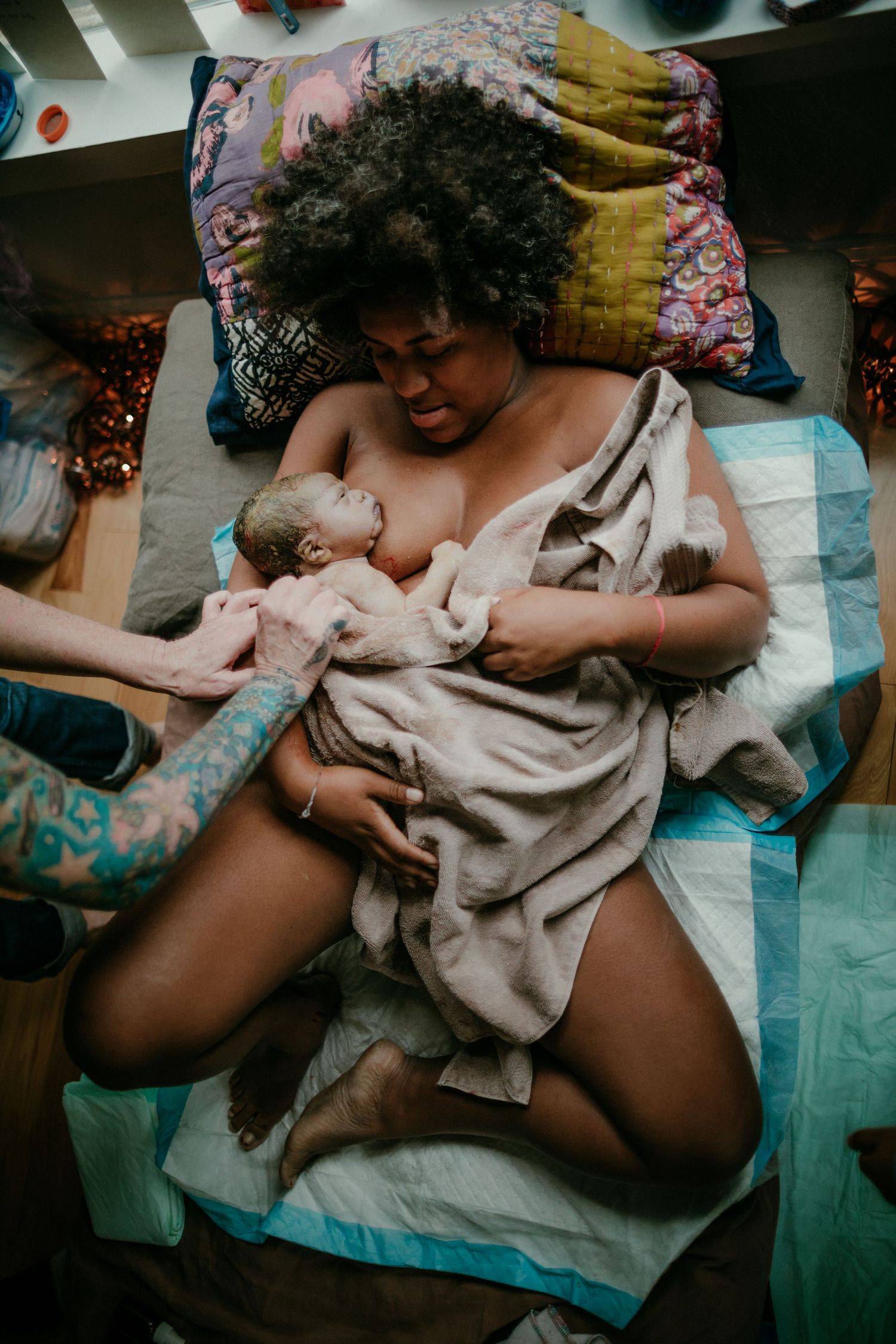 Black mother holds newborn after birth home birth photography portland oregon