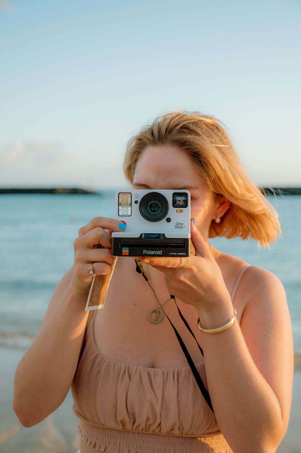 Portrait of girl holding polaroid camera