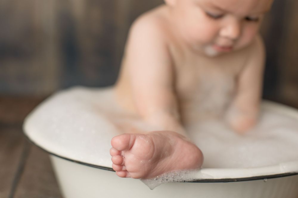 Close-up of baby's foot in white basin.