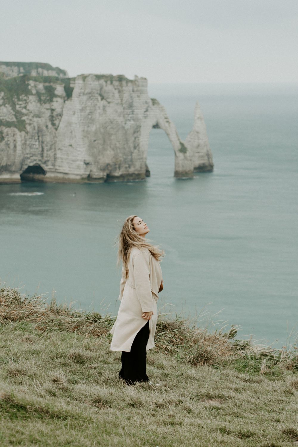 Young girl overlooking the cliffs in France