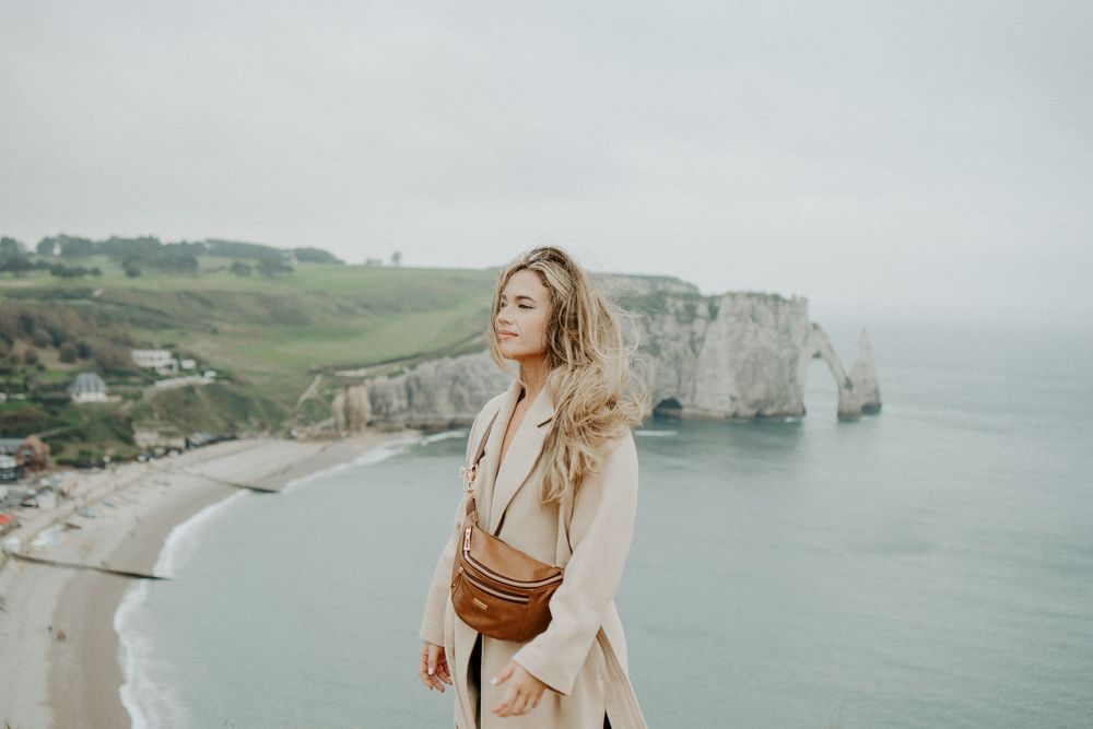 Young girl overlooking the beautiful cliffs in France. Beach