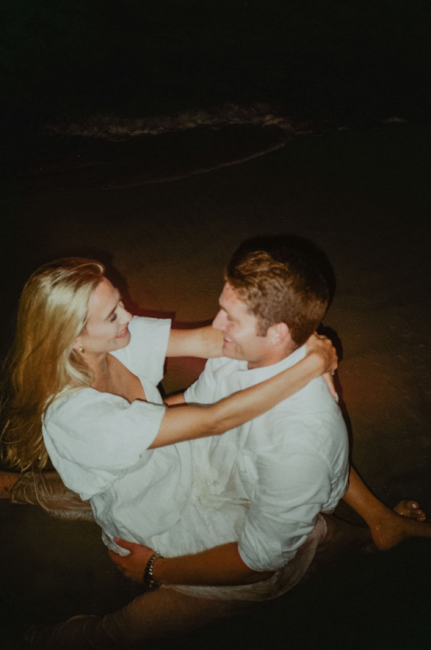 Newport beach sunset couple's engagement shoot on 35mm film camera during blue hour with flash