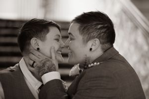 A tender romantic moment between two people sharing an intimate close-up kiss in black and white.