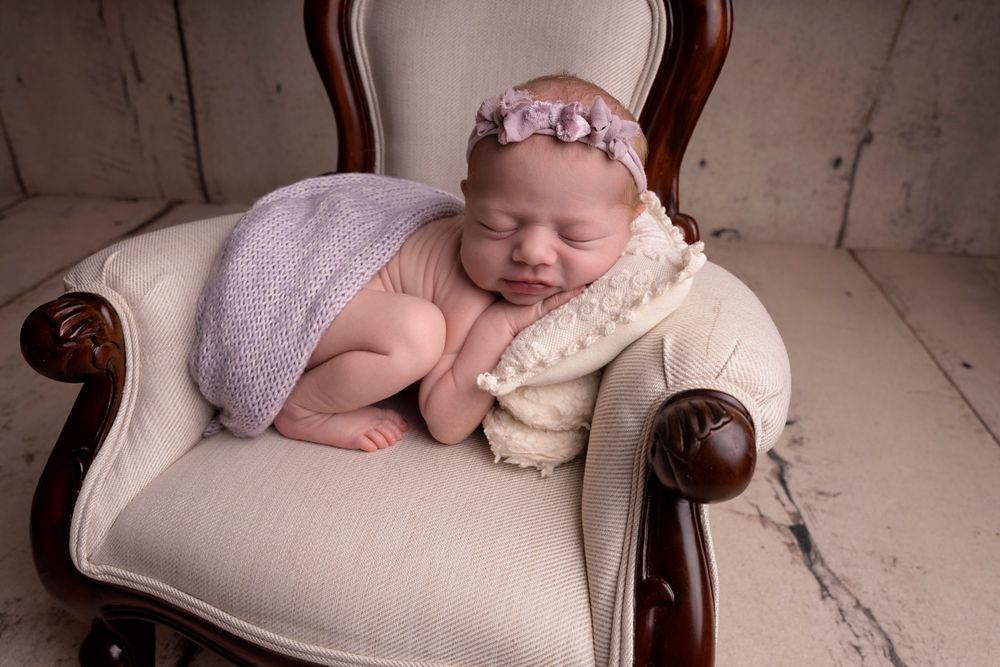 simple posed and styled in baby chair prop