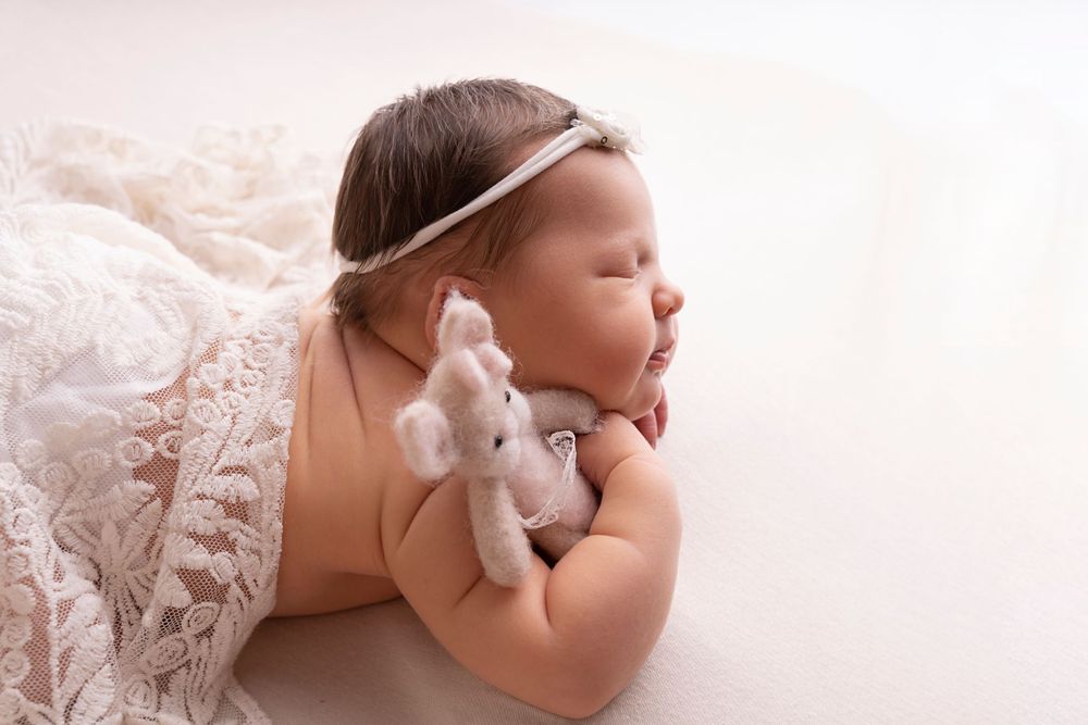 simple posed on baby's hand with teddy bear