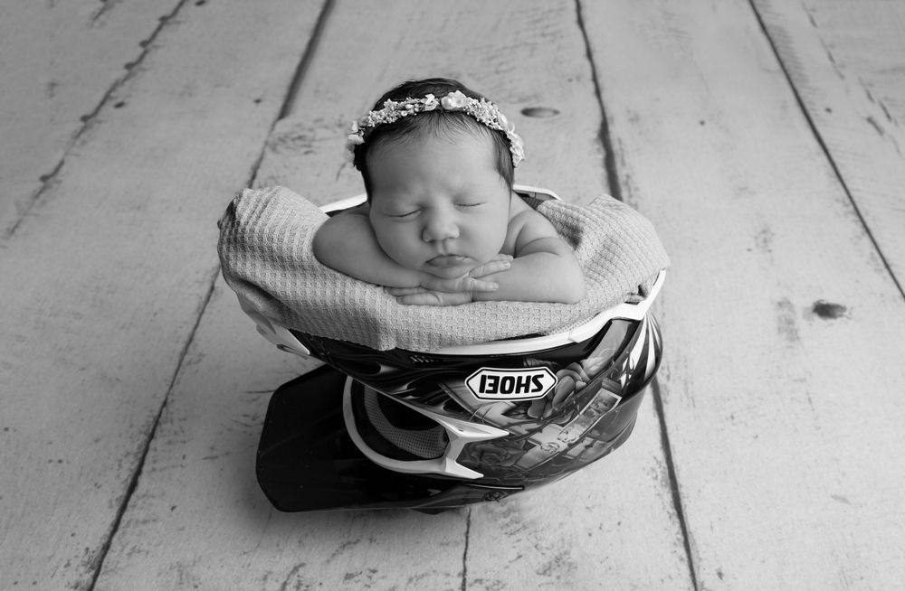 carefully posed in dad's helmet