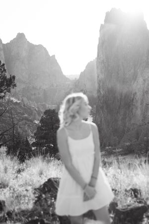 A dreamy black and white silhouette framed by dramatic mountain peaks.