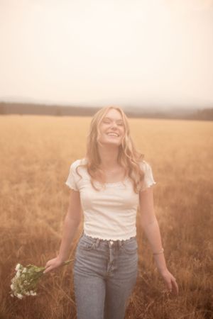 A joyful moment captured in a golden wheat field at sunset.