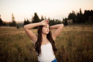 A serene summer portrait in a mountain meadow at golden hour.