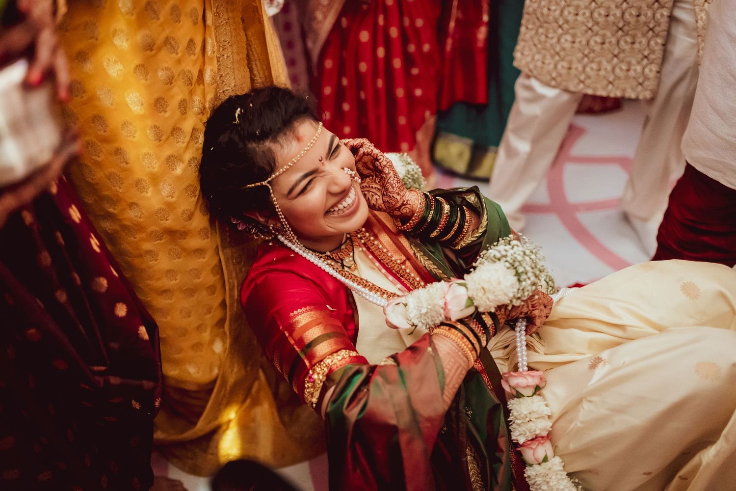 A bride giggling during her wedding ceremony in Pune