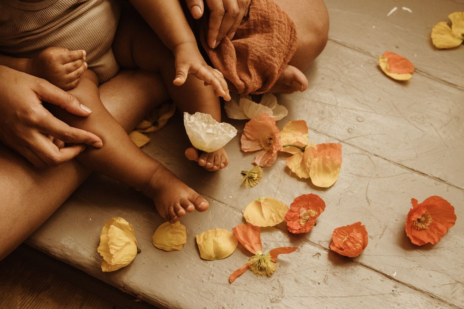 baby playing with flowers