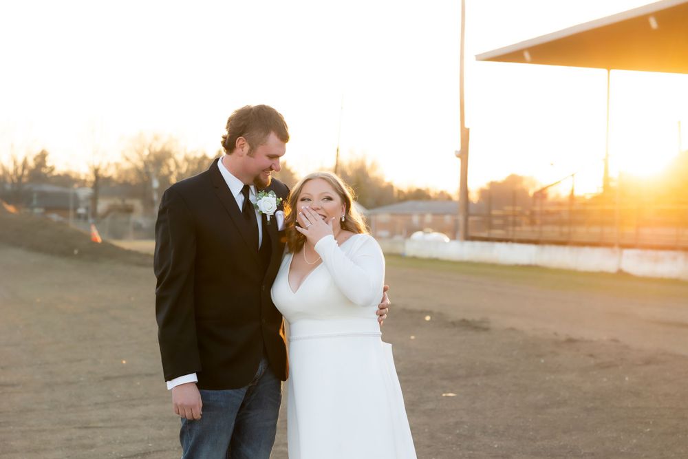 Sunset wedding portrait with warm golden light illuminating couple in casual formal attire.