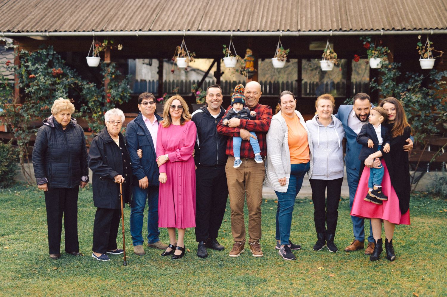 A large group of people standing together outdoors for a casual group photo.