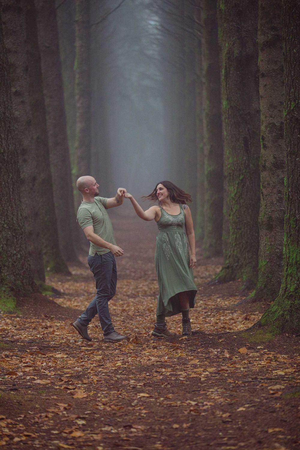 Couple in love dancing between tree lines