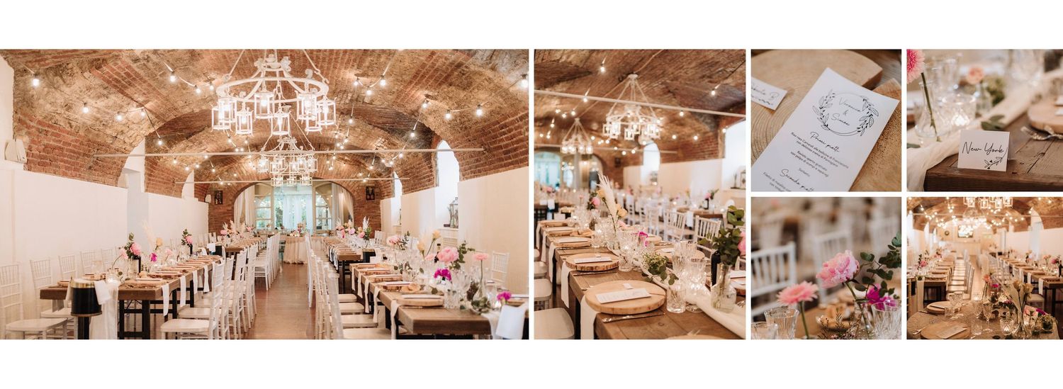 Elegant wedding reception hall with rustic wooden tables, chandelier lighting, and pink floral centerpieces.