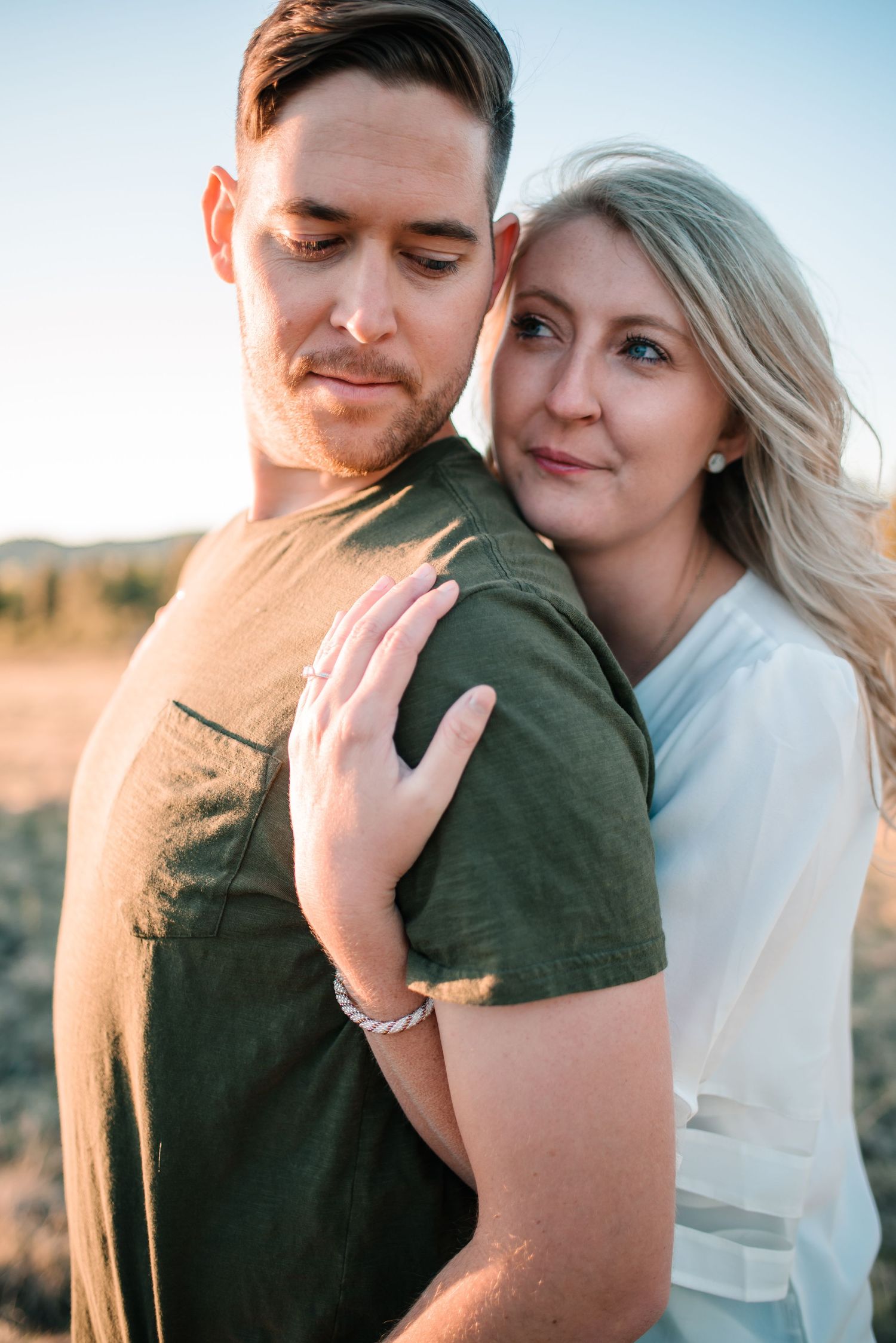 A romantic couple shares intimate embraces during their sunset photoshoot.