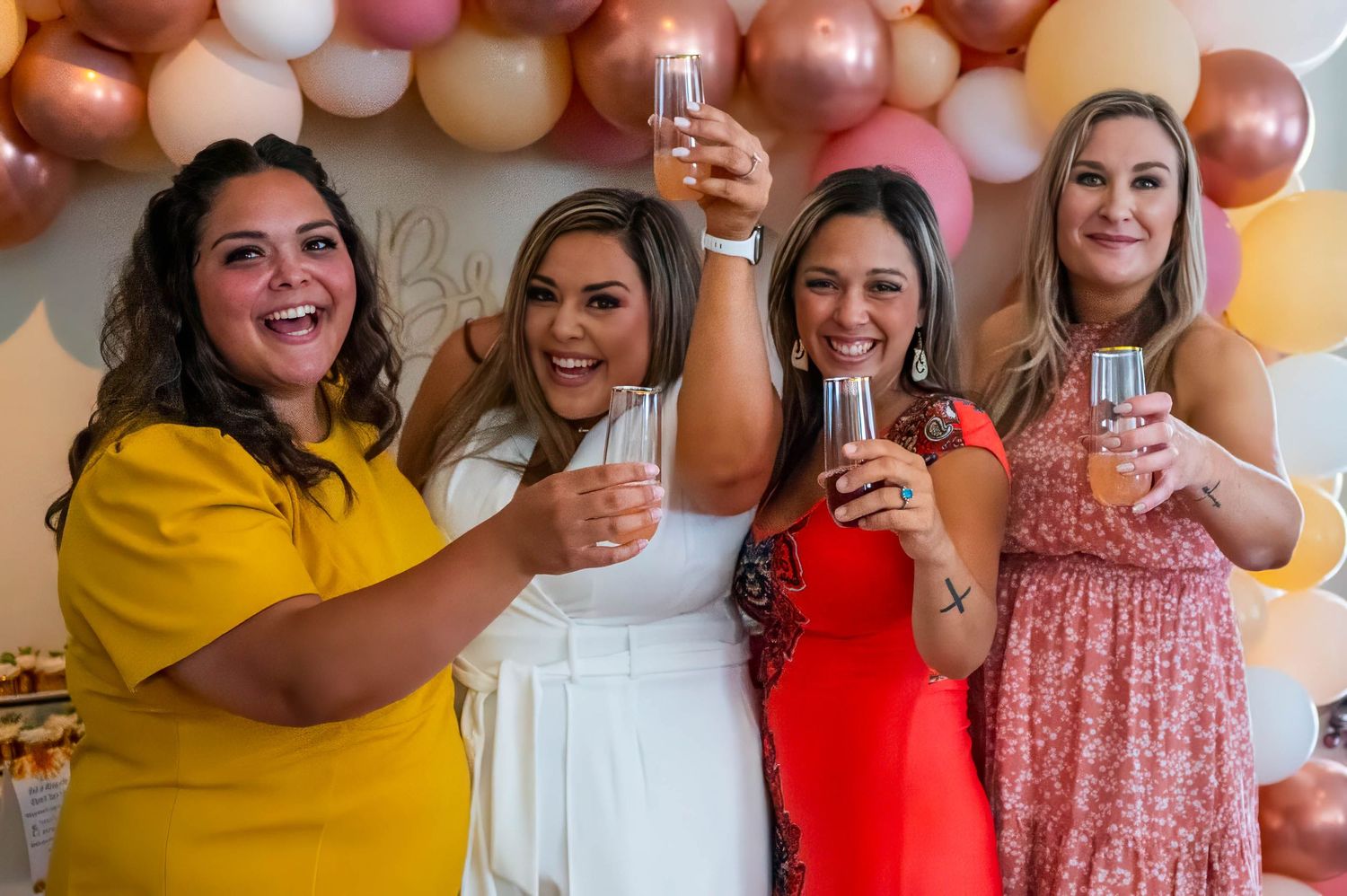 Bridal party at a bridal shower offering a toast to the bride.