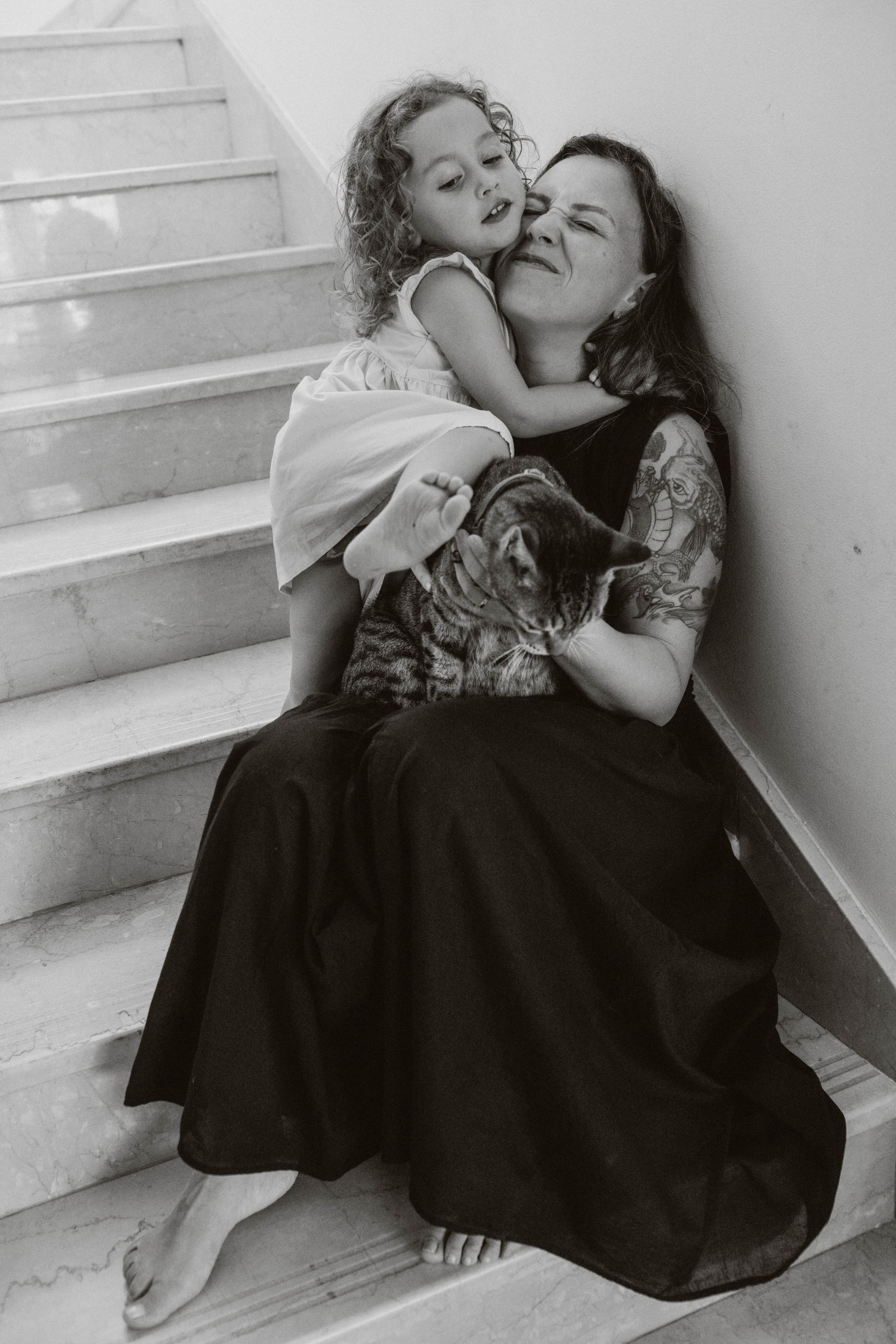 Playful family moment in Sydney & Northern Beaches, daughter climbing on her laughing mother, capturing love, connection, and joyful interac