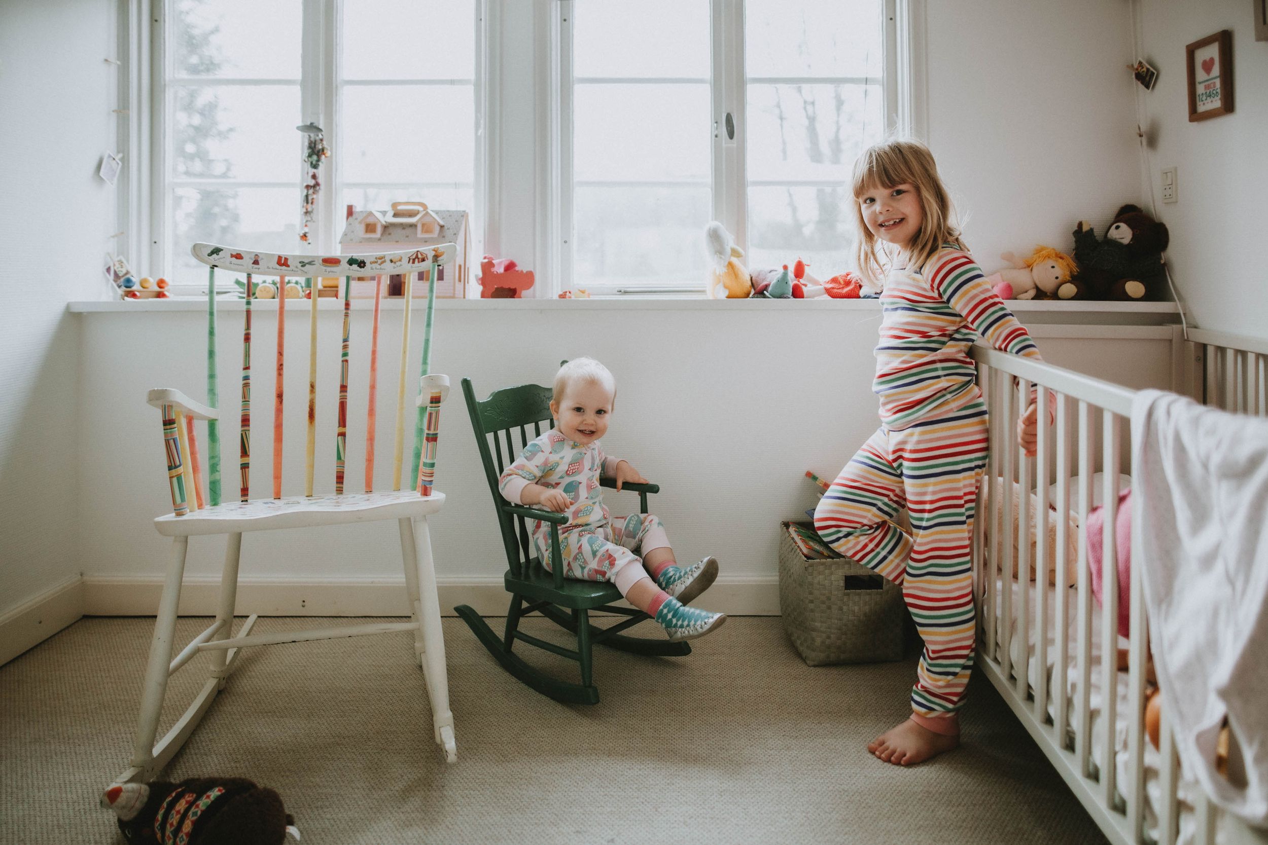 Family enjoying genuine and playful moments indoors with natural light, capturing children’s spontaneity and funny interactions.