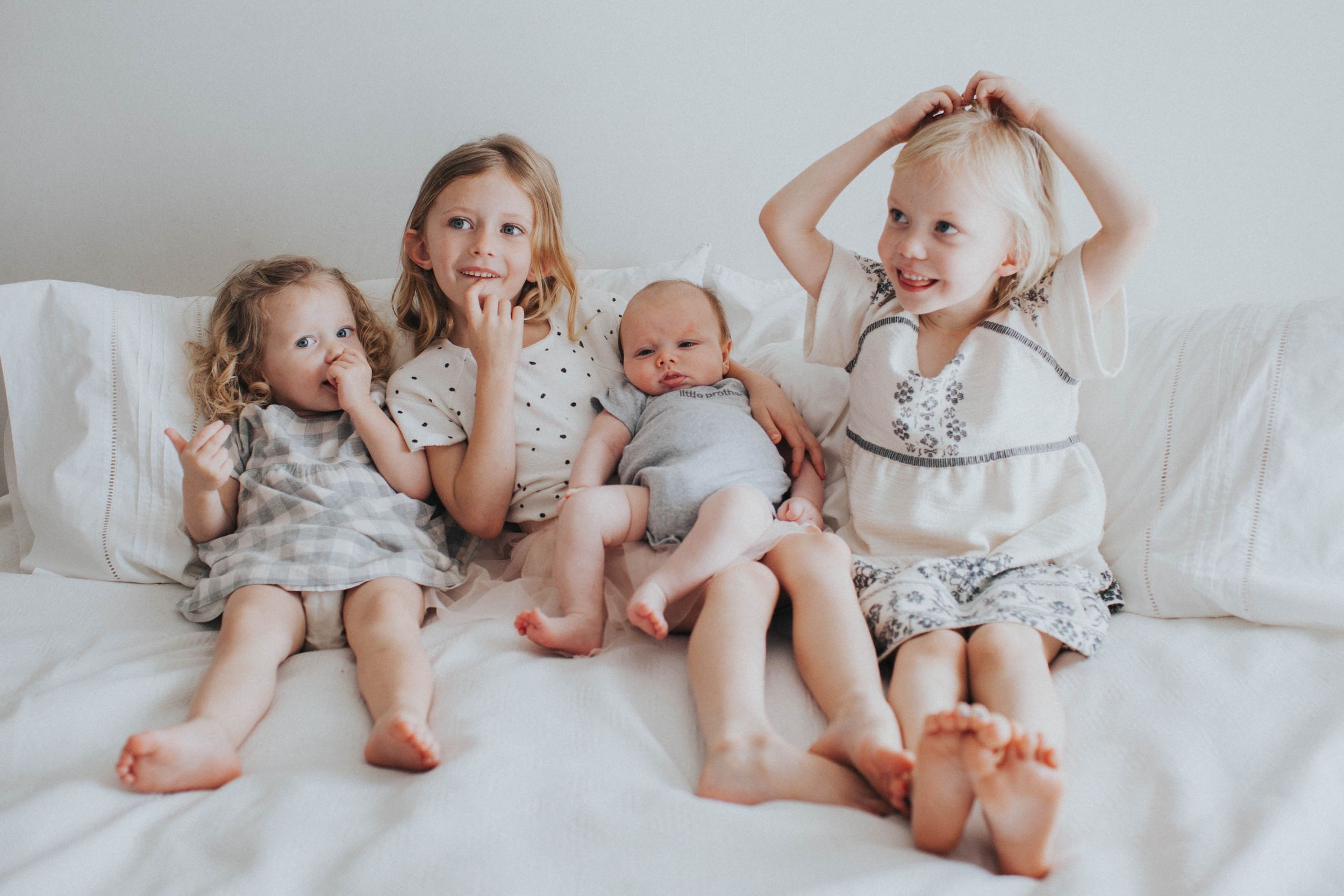 Family enjoying authentic lifestyle moments indoors with natural light, capturing love, connection, and spontaneous interactions.