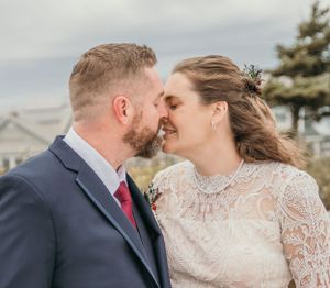 bride kissing groom on beach in Kennebunkport Maine