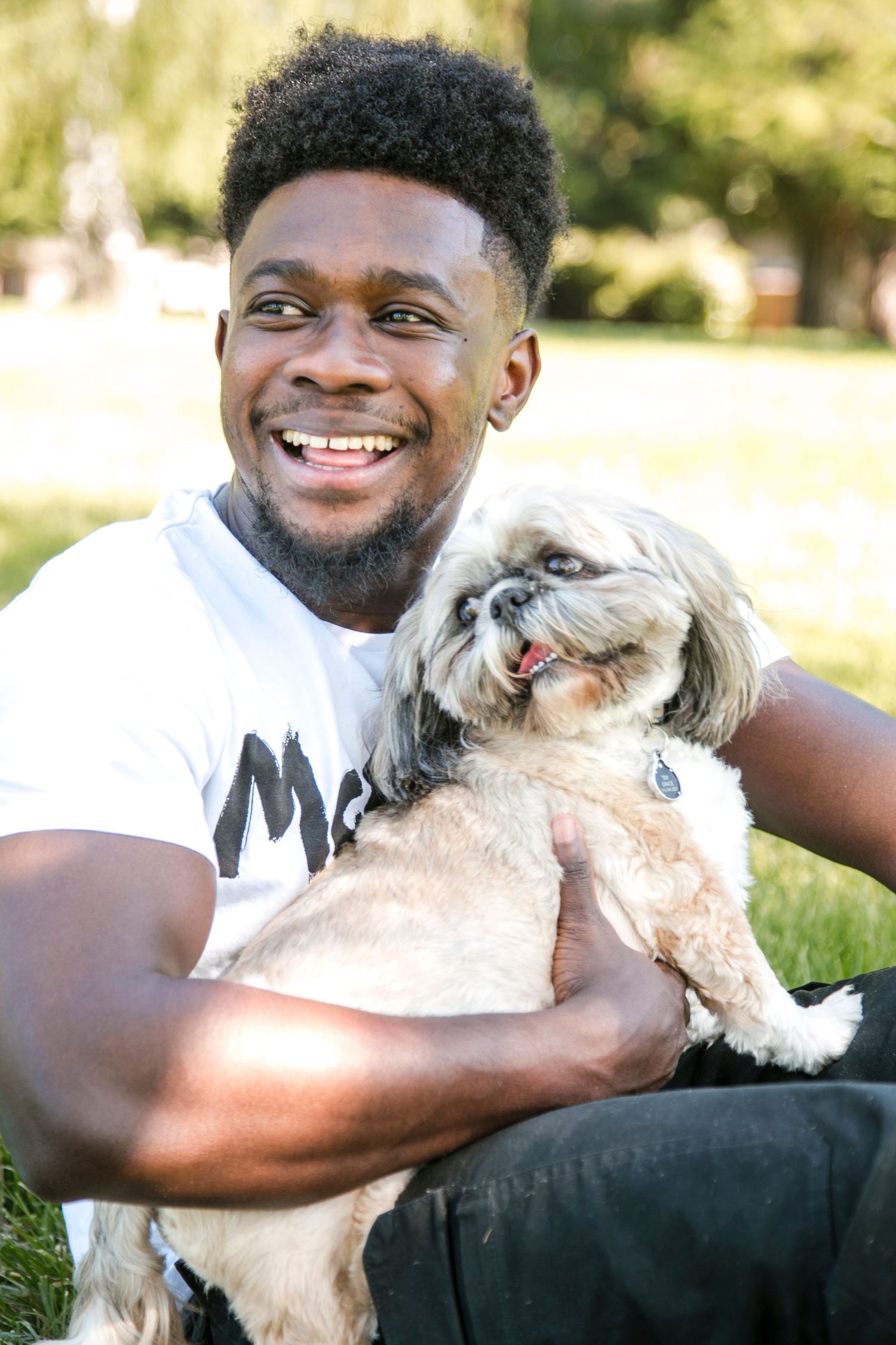 man and his dog smiling looking to the left