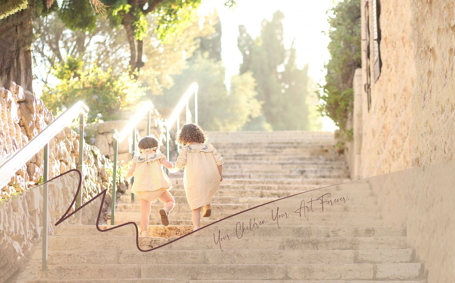 Two small figures sit on stone steps in sunlit alley with white railing.