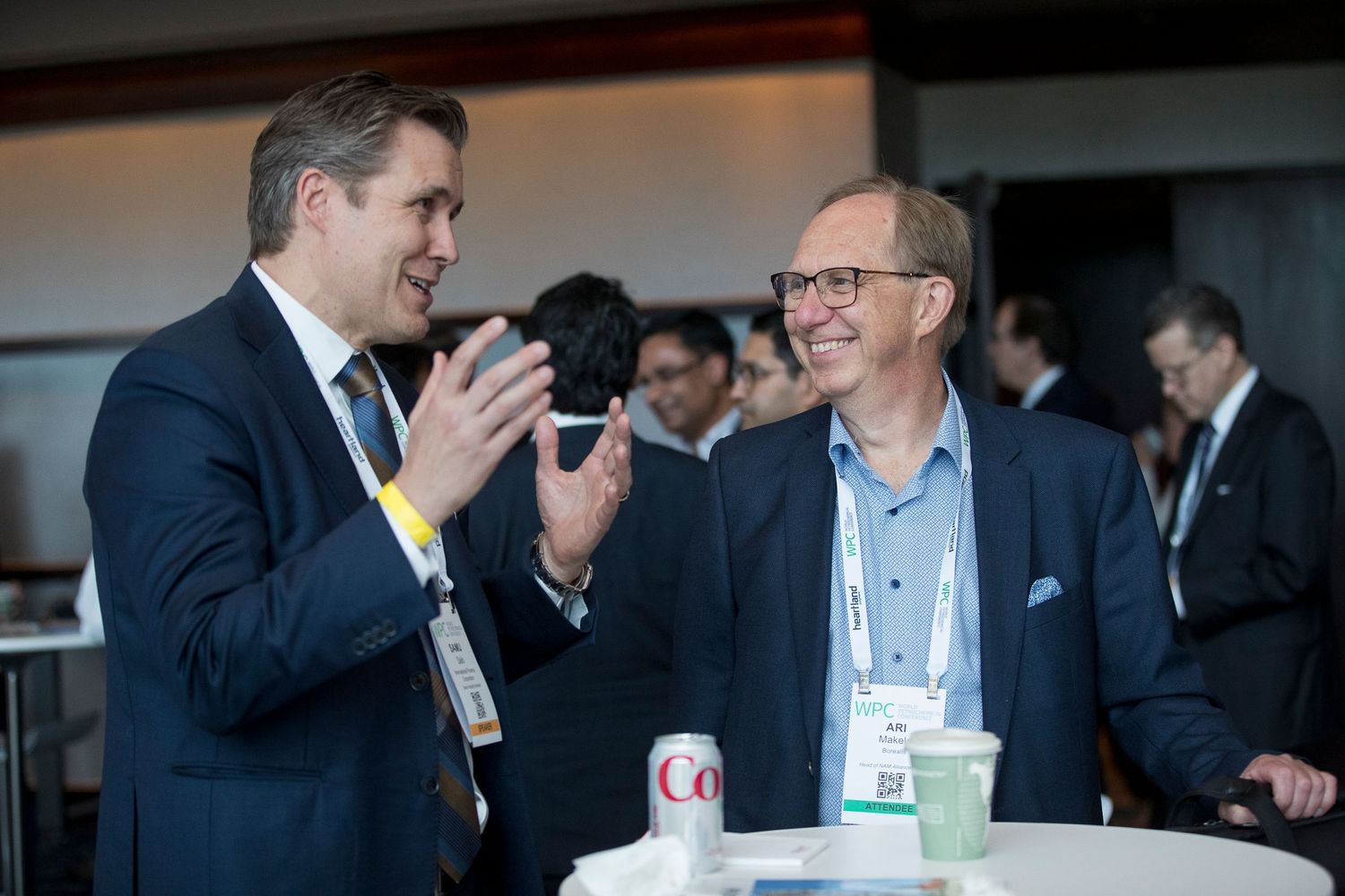 Business professionals engaged in animated discussion at a networking event.