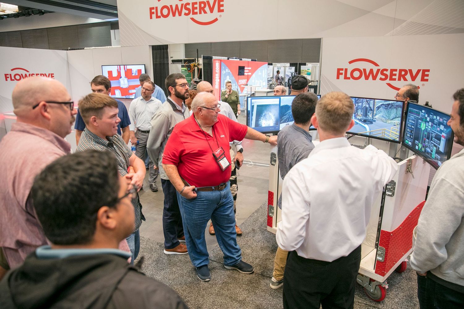 Trade show booth displaying Flowserve company branding and products.