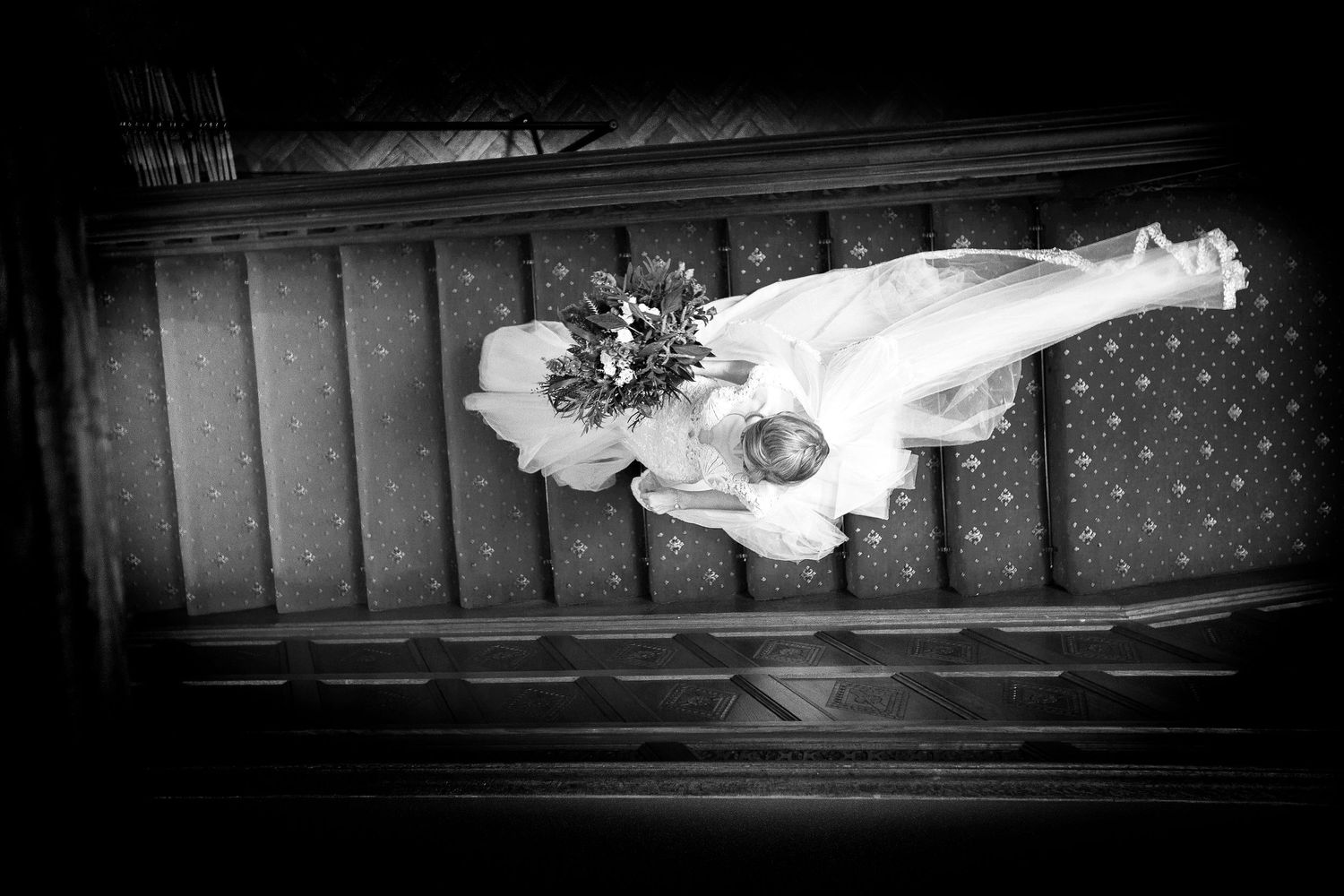bride walking downstairs view from above at manor by the lake cheltenham