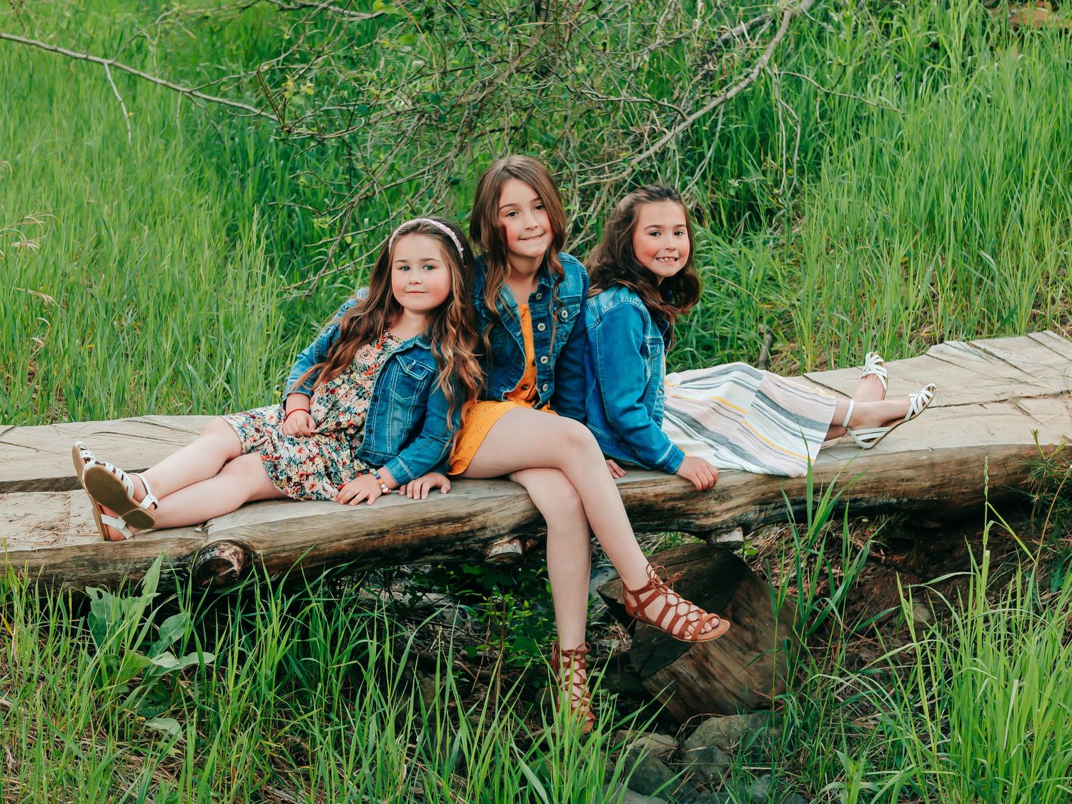 photo of sisters on wooden bridge
