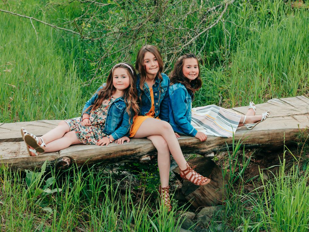 photo of sisters on wooden bridge
