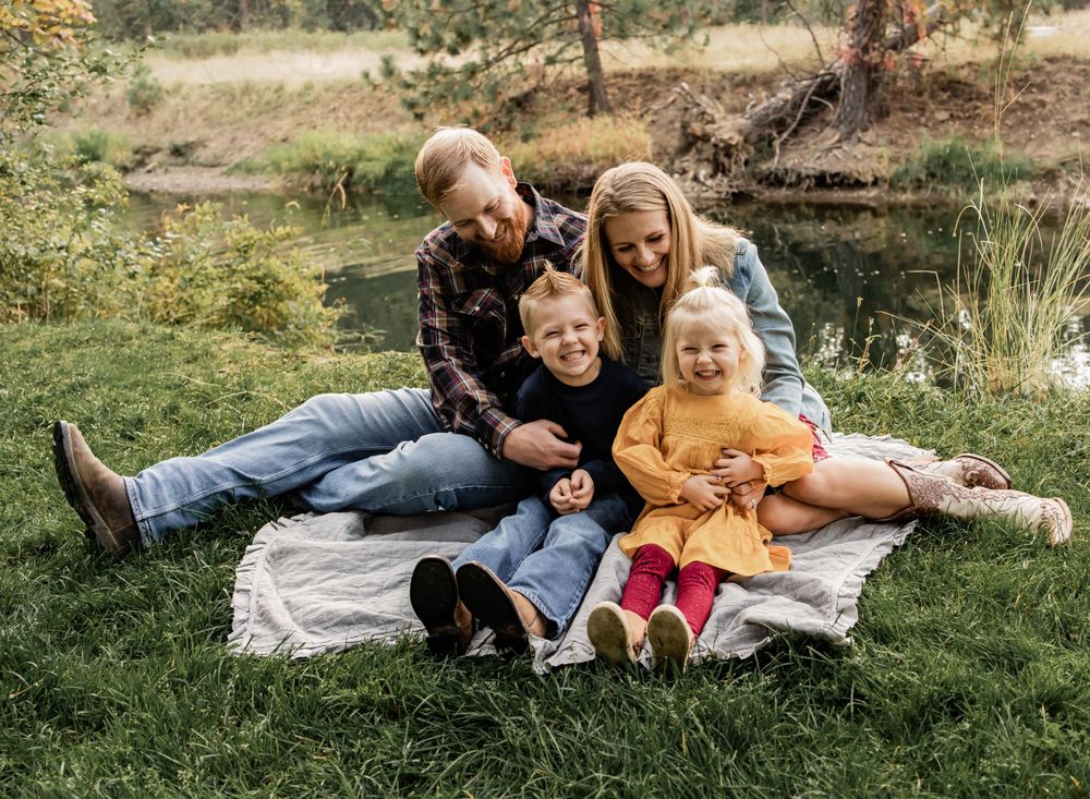 family laughing on grass