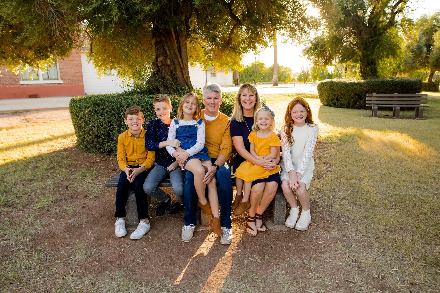 Golden glow of a farm setting for this extended family portrait session where every was posed and smiling in Phoenix Arizona.