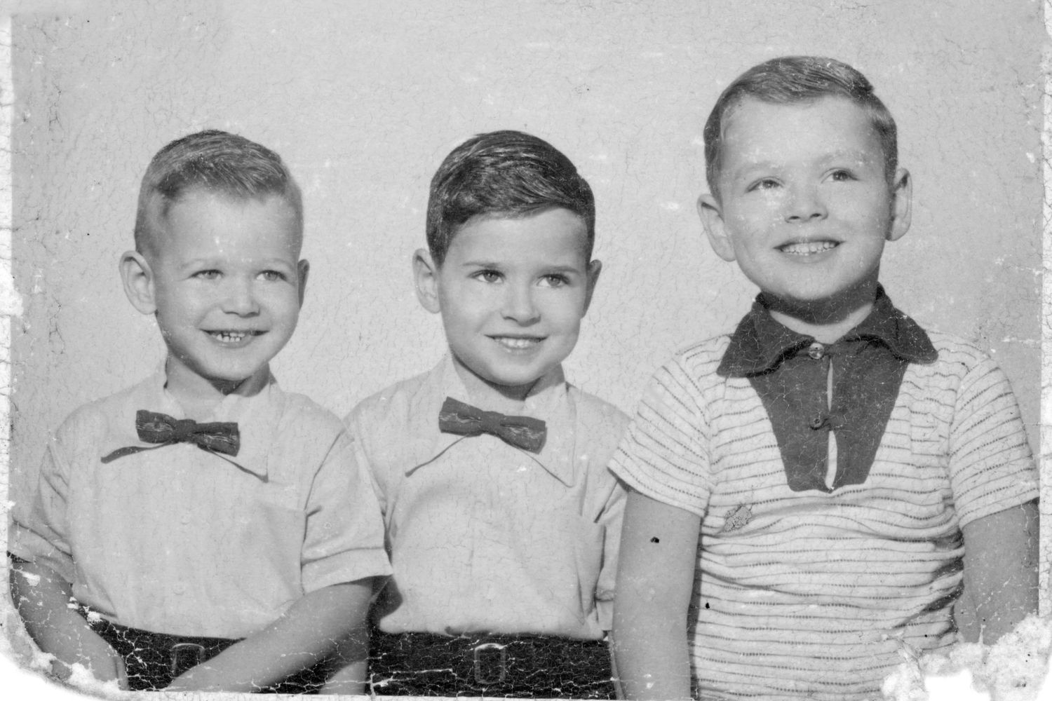 Vintage black and white portrait of three young boys in bow ties from the 1950s.