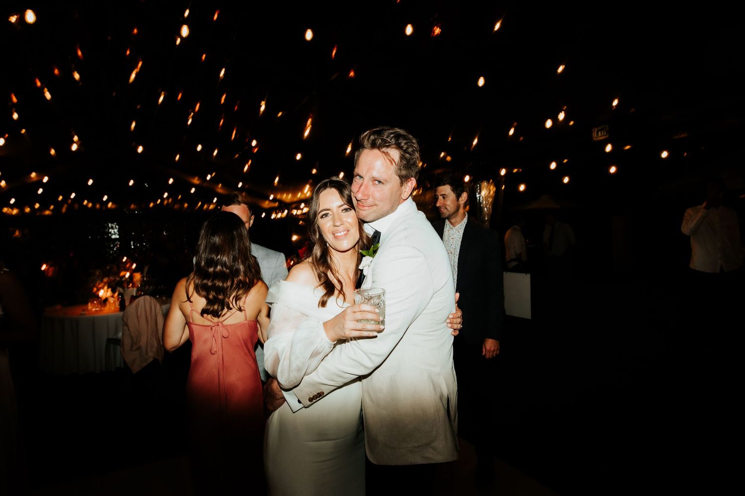 Wedding celebration under glowing lantern lights at night.