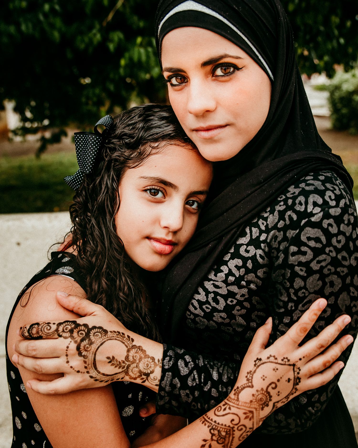 Muslin mom and daughter looking at the camera